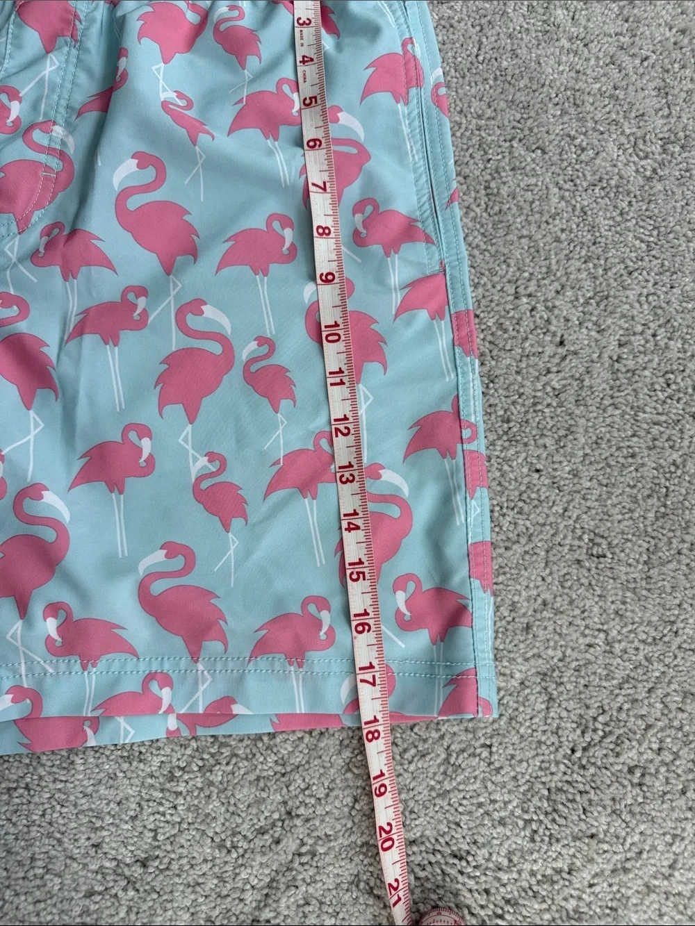 Elysian brand Men’s swim trunks in a blue and pink flamingo print- Size Medium